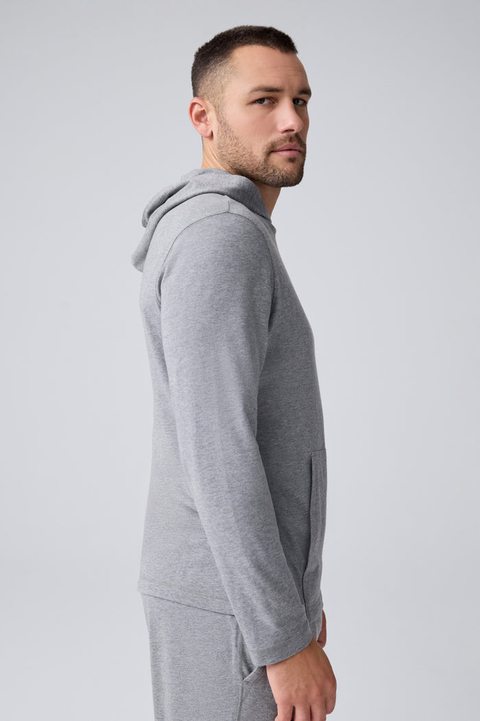 Side view of a man wearing 18-Hour Jersey Hoodie in Medium Grey Heather