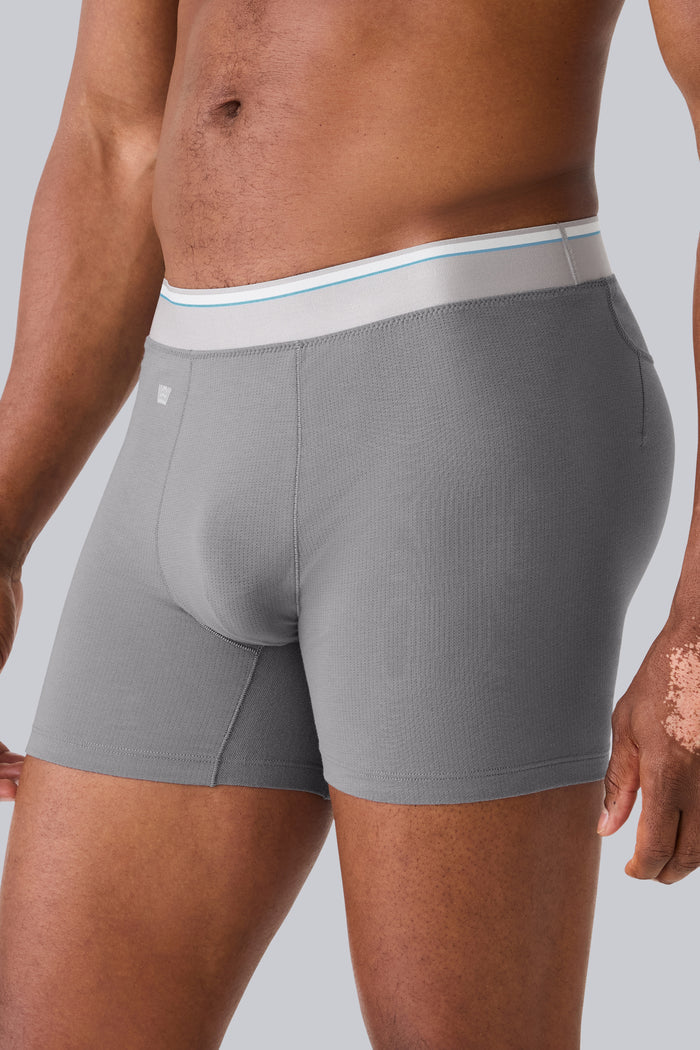 Side view of a man wearing AIRKNITx Cotton Boxer Brief in Steel