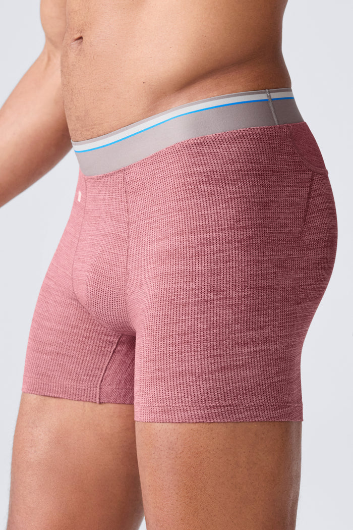 Side view of a man wearing Airknitx Boxer brief in Aged Port Heather