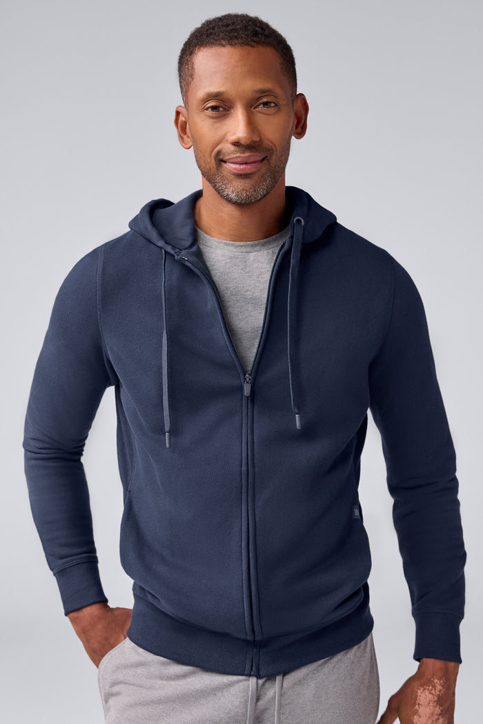Front view of a man wearing ACE Full-Zip Hooded Sweatshirt in Total Eclipse Blue