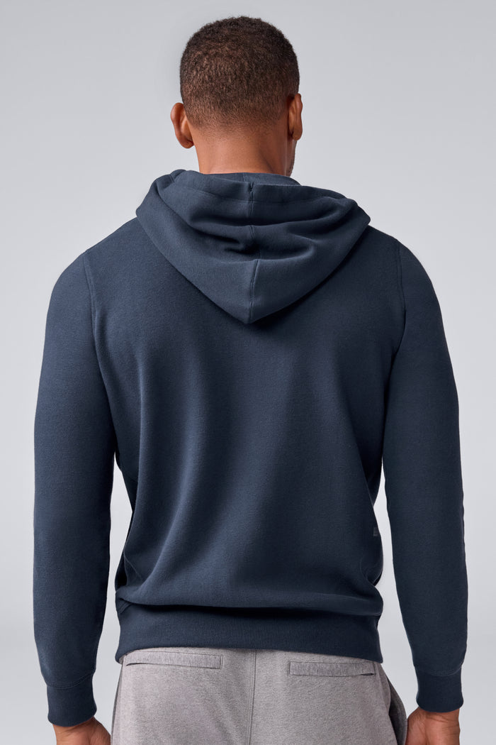 Back view of a man wearing ACE Full-Zip Hooded Sweatshirt in Total Eclipse Blue