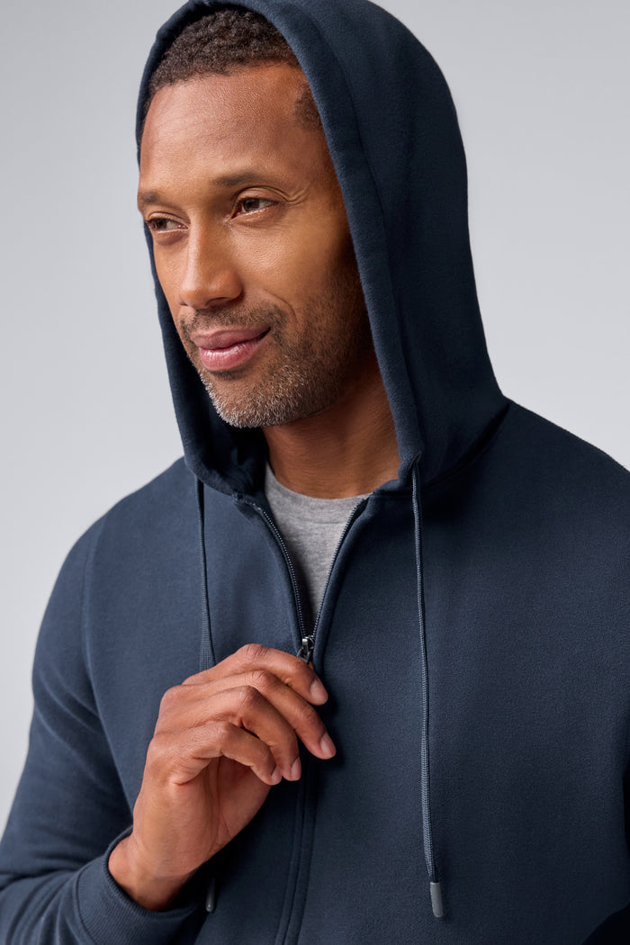 Detailed view of a man wearing ACE Full-Zip Hooded Sweatshirt in Total Eclipse Blue