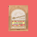 Brown kraft coffee bag from Morningsong with Alirio Muñoz Pink Bourbon Colombia label on a coral background