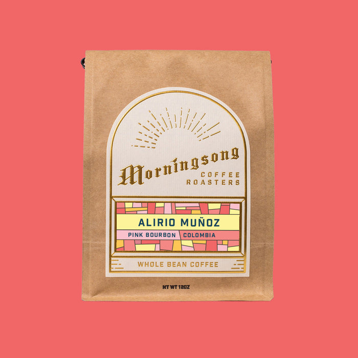 Brown kraft coffee bag from Morningsong with Alirio Muñoz Pink Bourbon Colombia label on a coral background