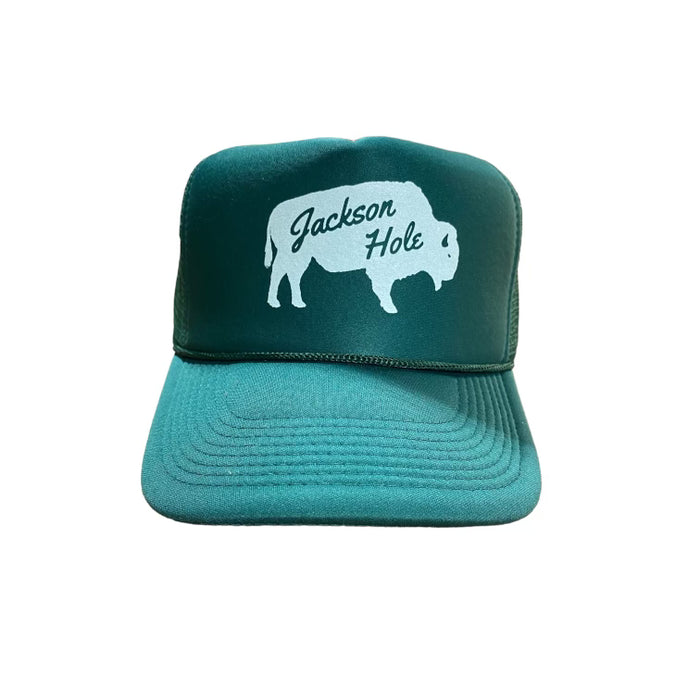 A dark green trucker hat with 'Jackson Hole' text and a silhouette of a bison on the front.