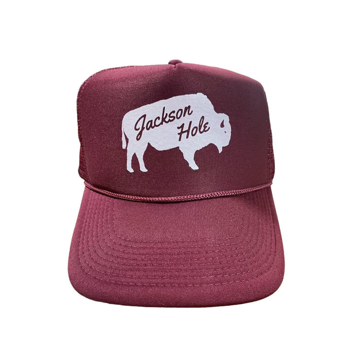A maroon trucker hat with 'Jackson Hole' text and a silhouette of a bison on the front.