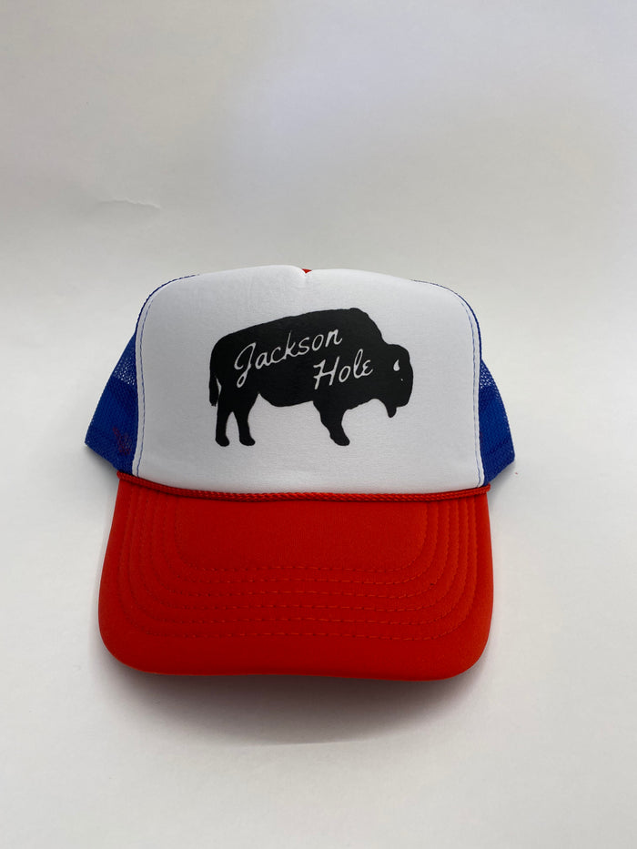 A red white and blue trucker hat with 'Jackson Hole' text and a silhouette of a bison on the front.