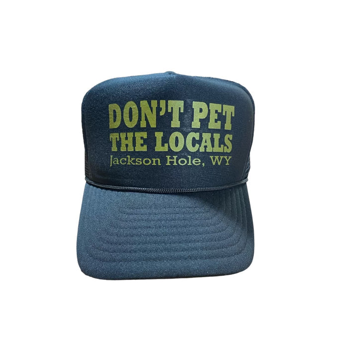 A black baseball cap with text 'DON'T PET THE LOCALS Jackson Hole, WY' on the front.