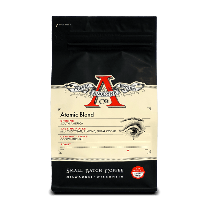 Atomic Blend packaging front with cream label and vintage style illustration and red emblem