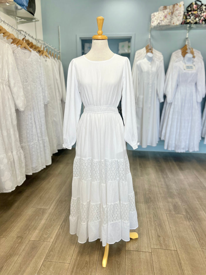 White dress with tiered lace panel skirt.