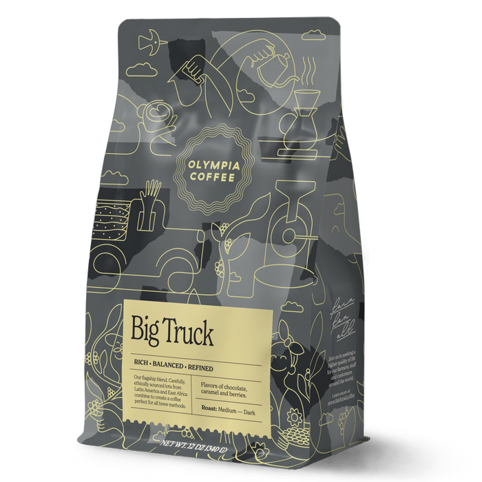 Big Truck coffee bag with yellow label and intricate abstract line art on a dark package