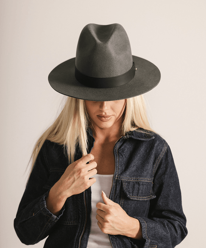Woman wearing a grey fedora hat on a white background #color_dark grey