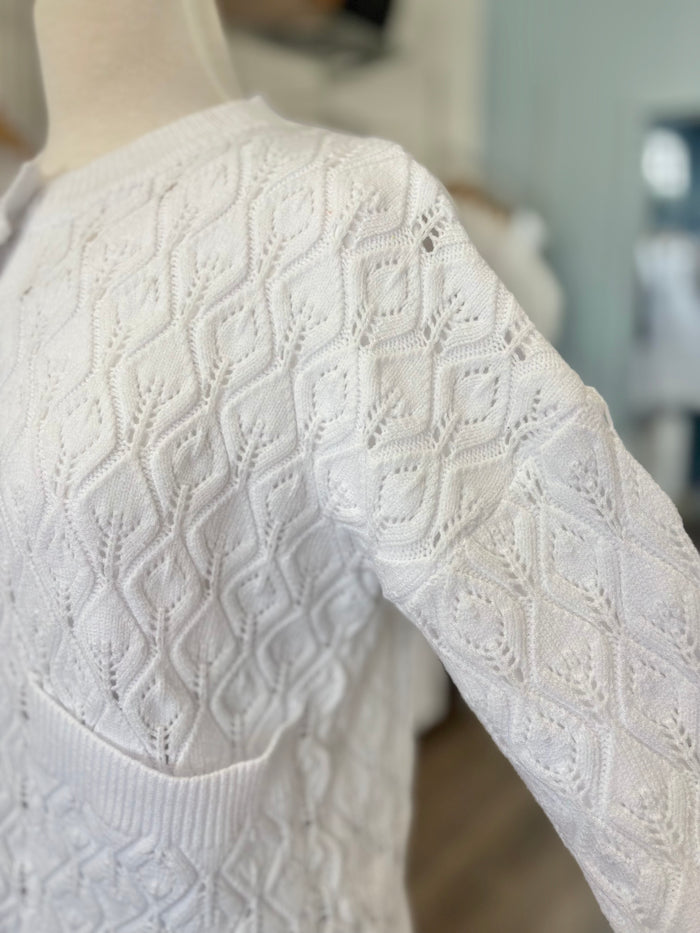 White cable knit button up cardigan.