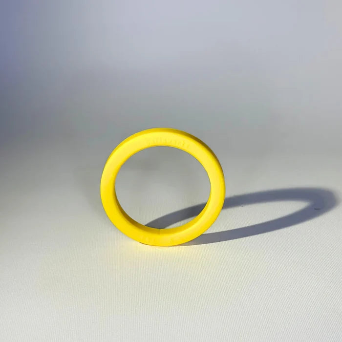 Bright yellow silicone gasket for E61 group head placed on a white background.