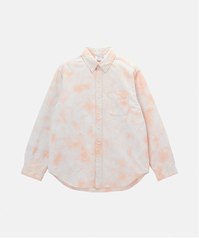 Model wearing a Gramicci peach Bleach Stripe colored Classic Oxford Bleached Shirt against a light-tone background.