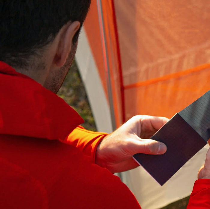 Fixing a tear in a tent using Coghlans nylon tent repair kit