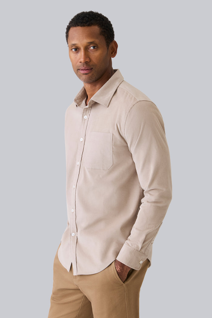 Side view of a man wearing Corduroy Button Up Shirt in Stone