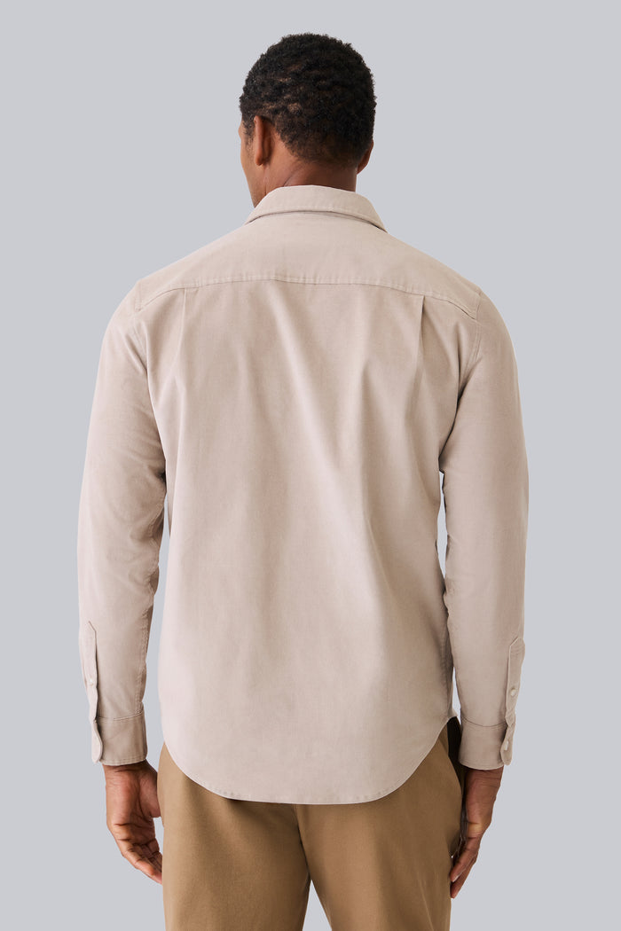 Back view of a man wearing Corduroy Button Up Shirt in Stone