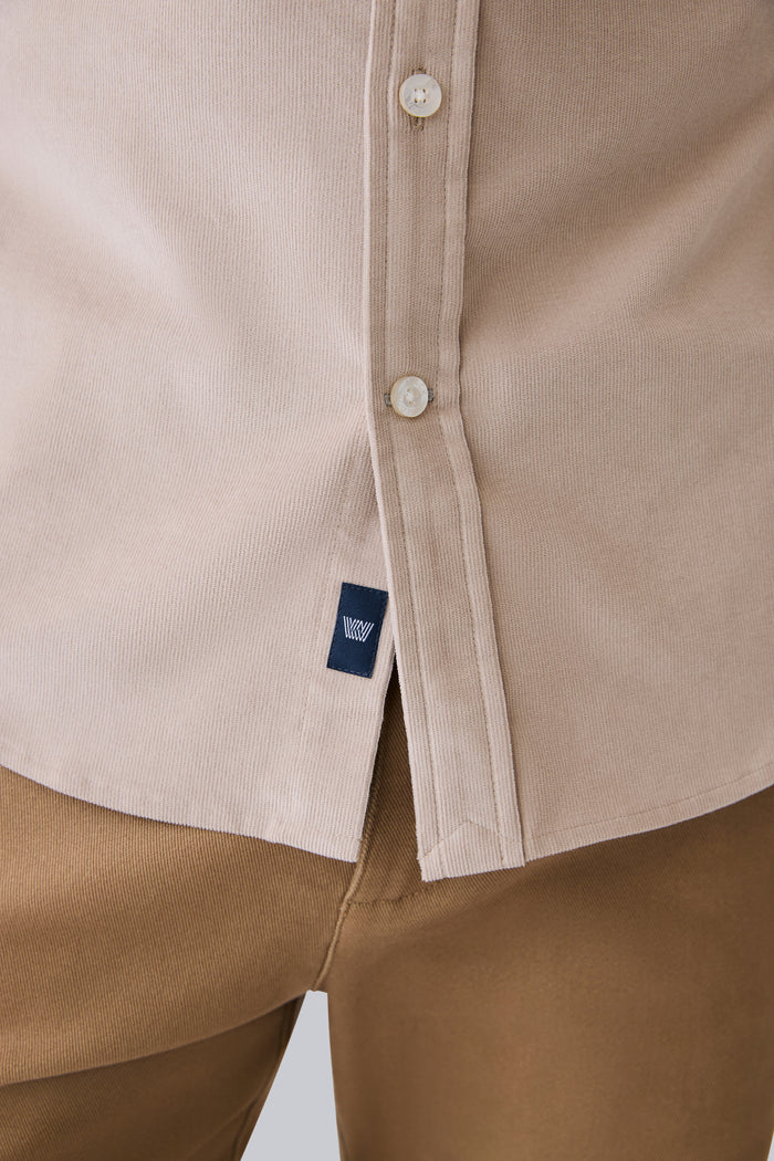 Close up look of Corduroy Button Up Shirt in Stone with Mack Weldon logo