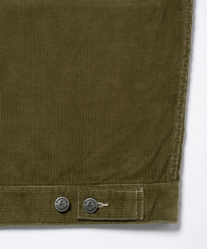 Close-up of a olive Gramicci Corduroy Trucker Jacket on a light-tone background.