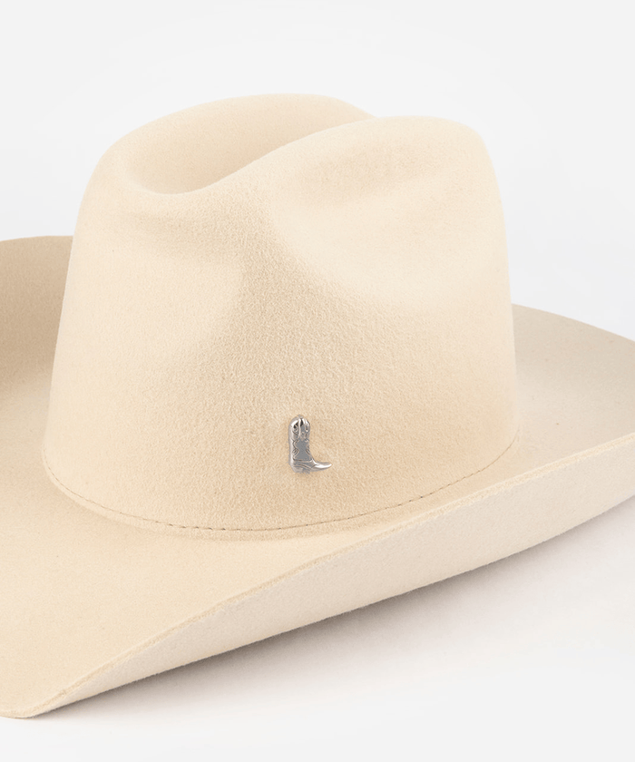 Pink cowboy hat with a silver boot-shaped hat pin on a white background #color_silver