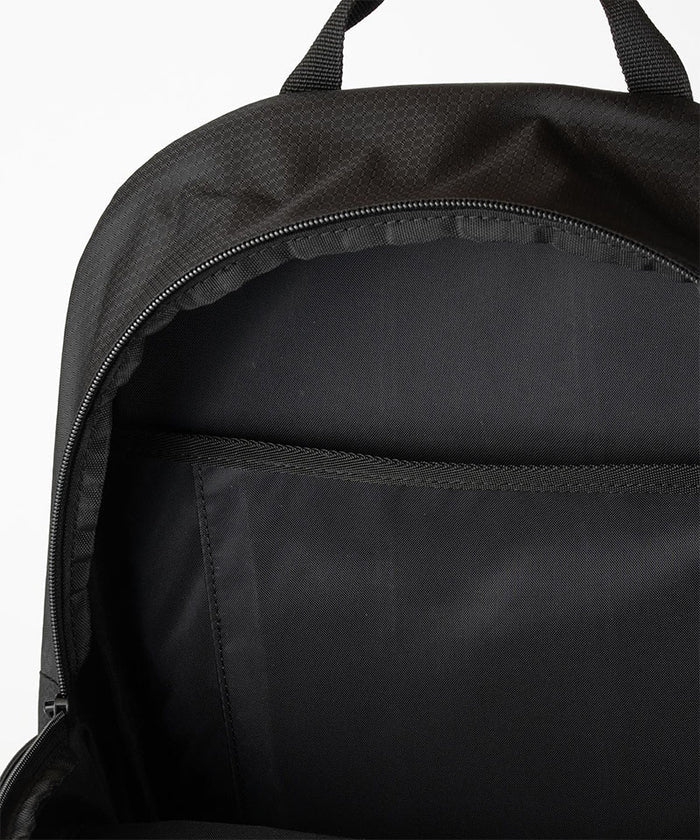 Close-up of Gramicci Day Pack 25L backpack interior in the color black against a light-tone background.