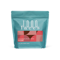 Teal 1000 Faces Decaf coffee bag with a red geometric label reading DECAF.