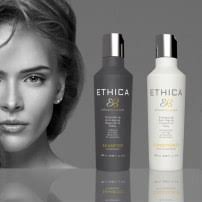 Two Ethica haircare bottles, one dark gray and one white, shown against a dark gray background with a blurred grayscale portrait of a woman on the left.