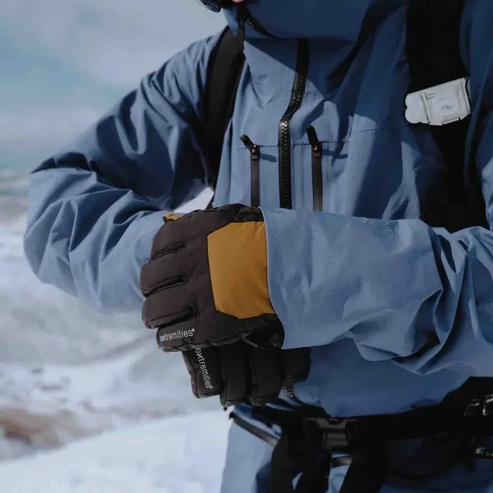 Mountaineer wearing Extremities Capitol Peak waterproof gloves whilst on advnentures in the snow.