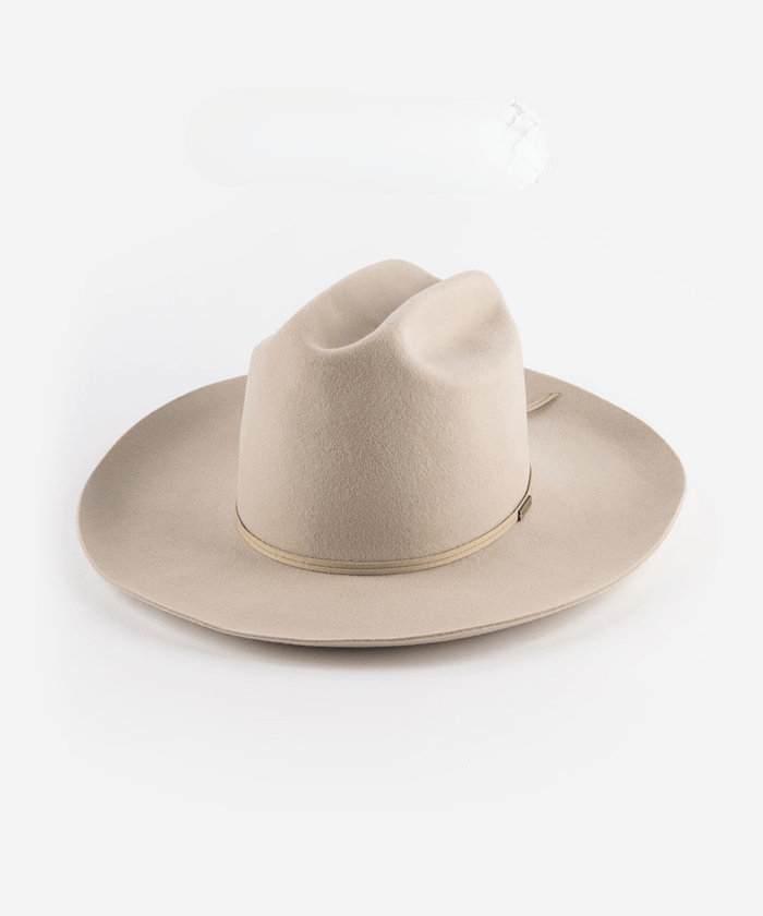 An ivory colored cowboy hat with a hat band on a white background #color_ivory
