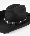 Black cowboy hat with decorative band and conchos on a white background #color_black