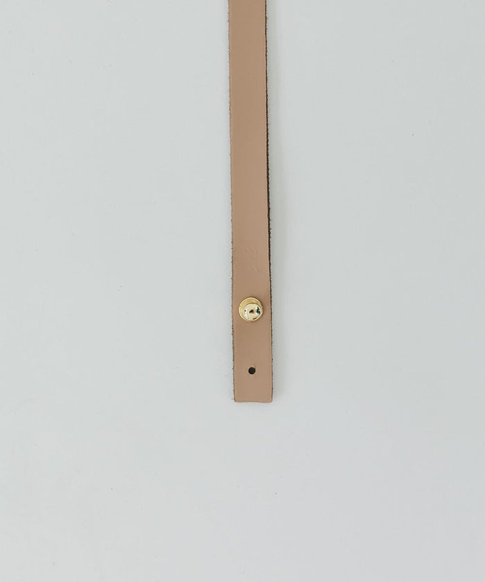 A tan genuine leather thin hat band with a pin on a white background #color_tan