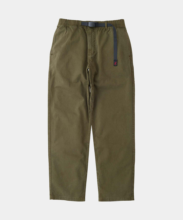 Pine colored Gramicci Pants with a belt against a light-tone background.