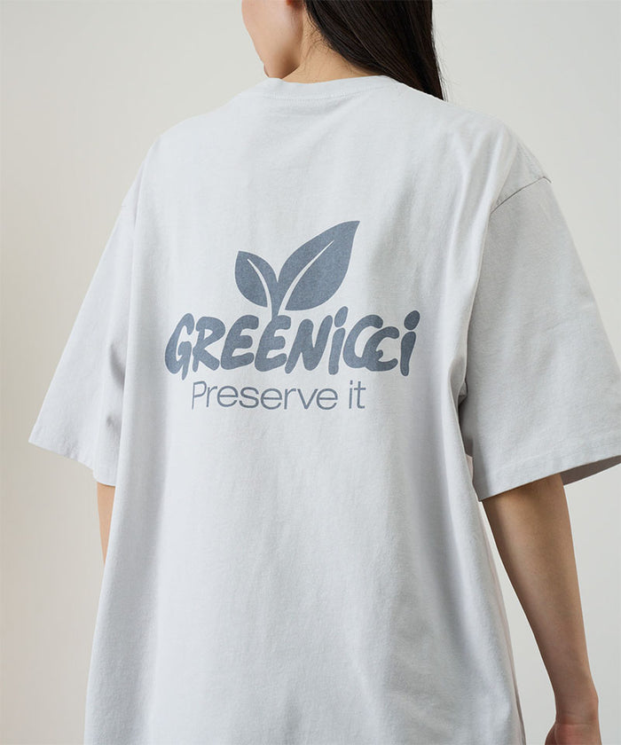 Back view of a model wearing a Gramicci smoke colored Greenicci Tee with a graphic against a light tone background.
