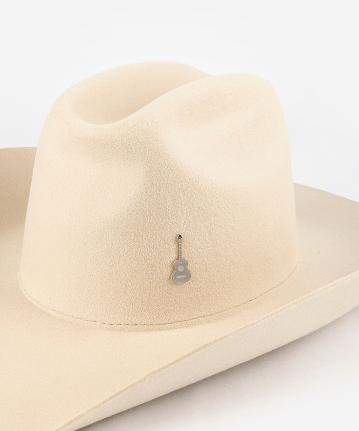Pink cowboy hat with a silver guitar-shaped hat pin on a white background #color_silver