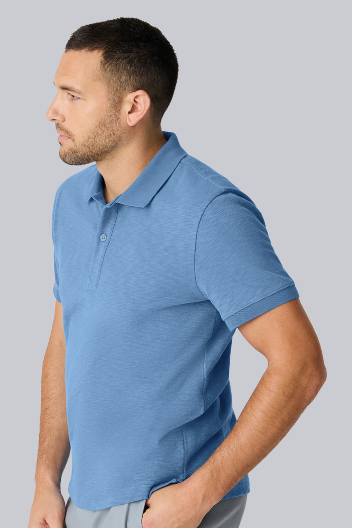 Side view of a man wearing Heavyweight Slub polo in Dean Blue