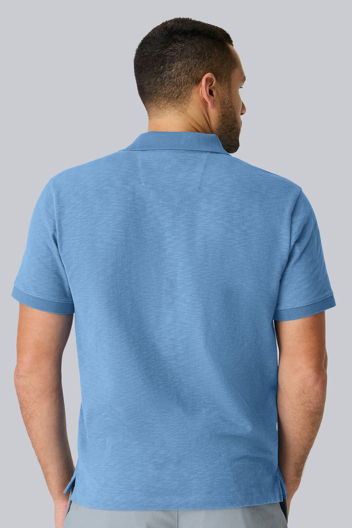 Back view of a man wearing Heavyweight Slub polo in Dean Blue