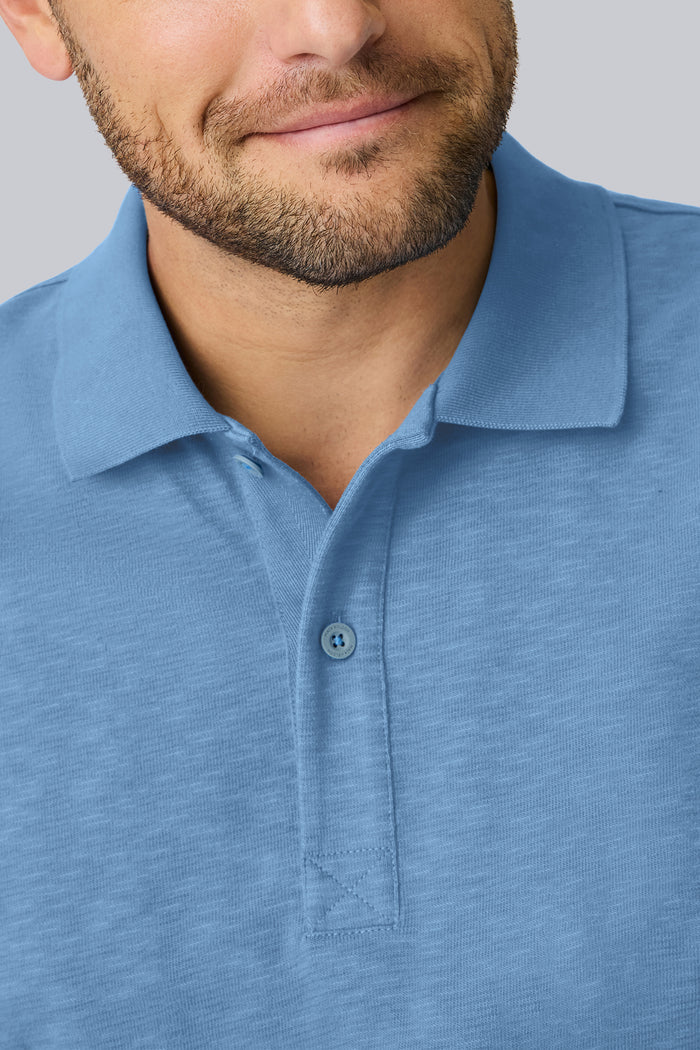 Detailed collar view of a man wearing Heavyweight Slub polo in Dean Blue