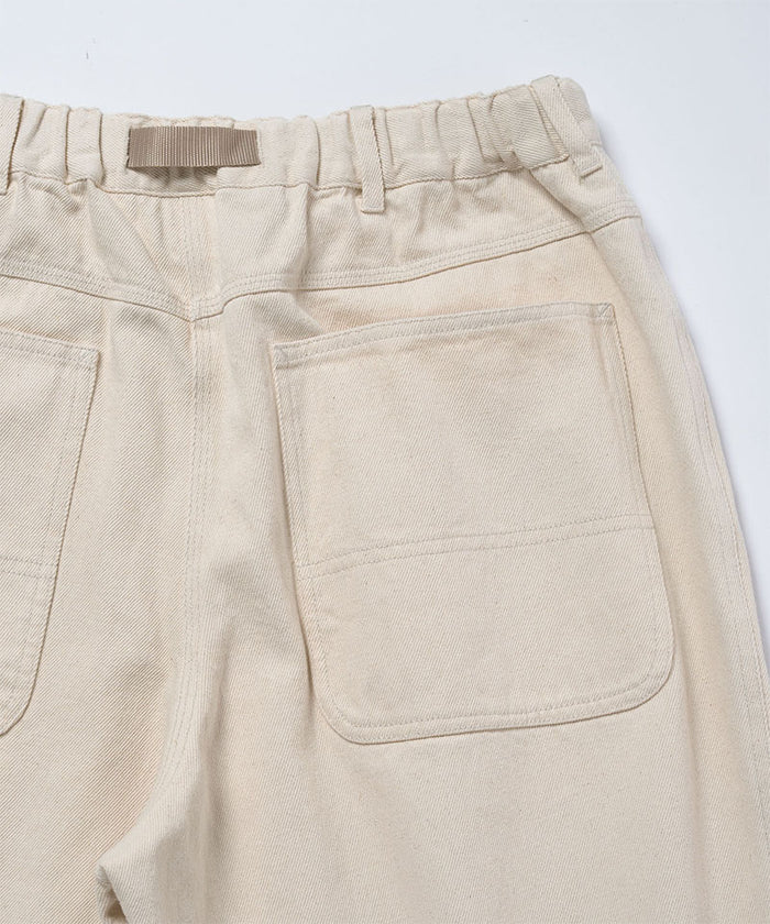 Back view close-up of natural colored Gramicci Hemp Denim Pants on a light-tone background.