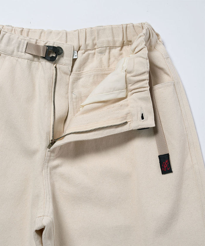 Close-up view of natural colored Gramicci Hemp Denim Pants on a light-tone background.