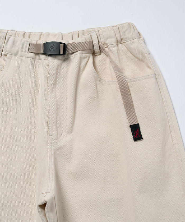 Close-up view of natural colored Gramicci Hemp Denim Pants on a light-tone background.