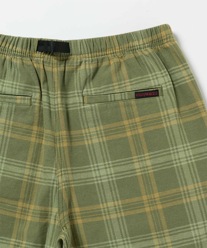 Back view close-up of olive plaid Gramicci Hemp G-Short Plaid on a light-tone background.
