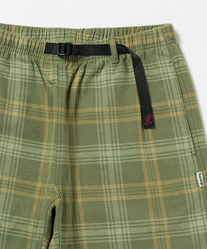 Close-up view of olive plaid Gramicci Hemp G-Short Plaid on a light-tone background.