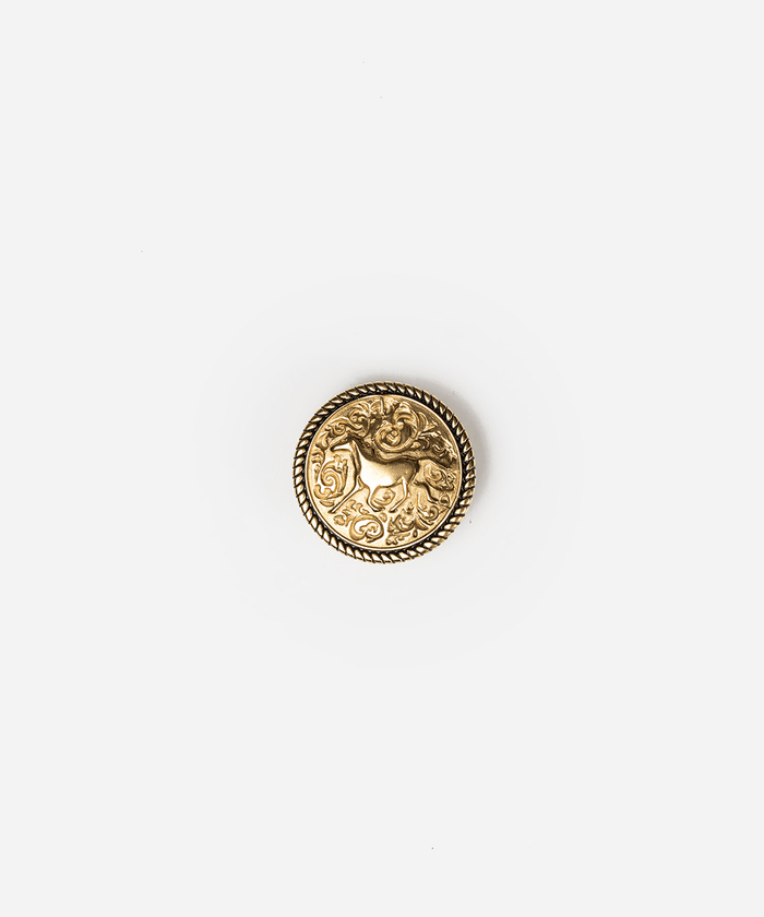 A single round gold-toned decorative button with an embossed animal motif and rope-style border, centered on a plain light gray background #color_gold