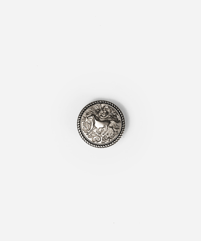 A single round silver-toned decorative button with an embossed animal motif and rope-style border, centered on a plain light gray background #color_silver