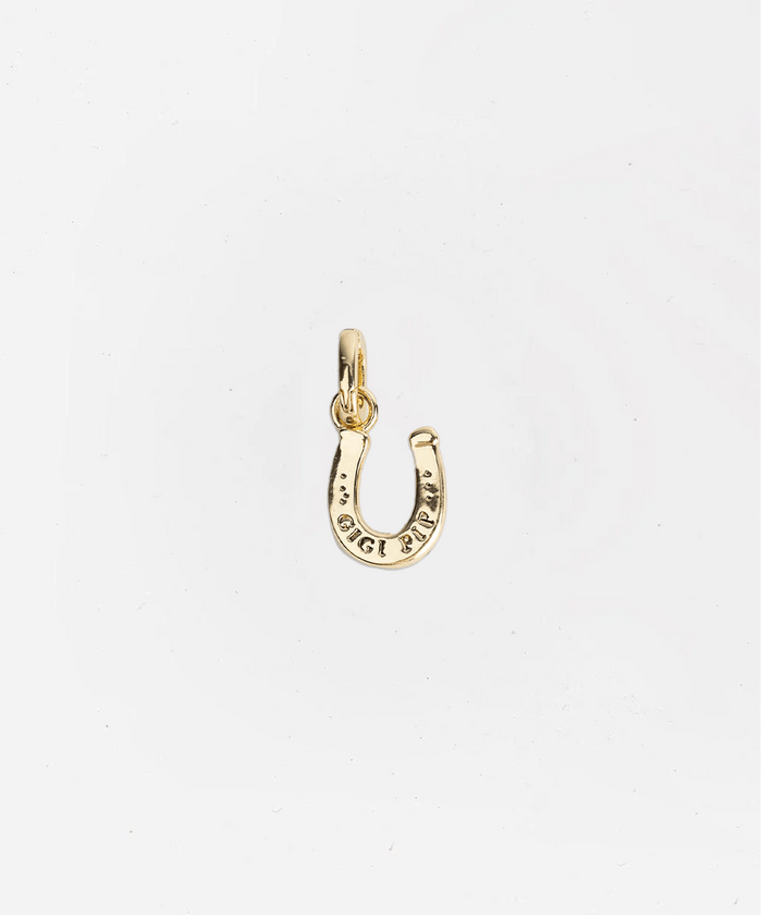Gold horseshoe charm on a white background #color_gold