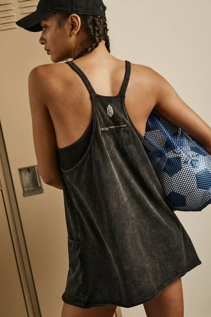 Person wearing Free People Hot Shot Mini Dress Black with drawstring bag with a blue and white pattern.