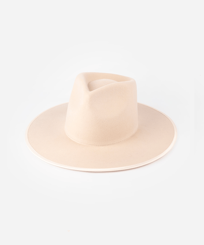 A nude colored fedora hat against a plain background #color_pale nude