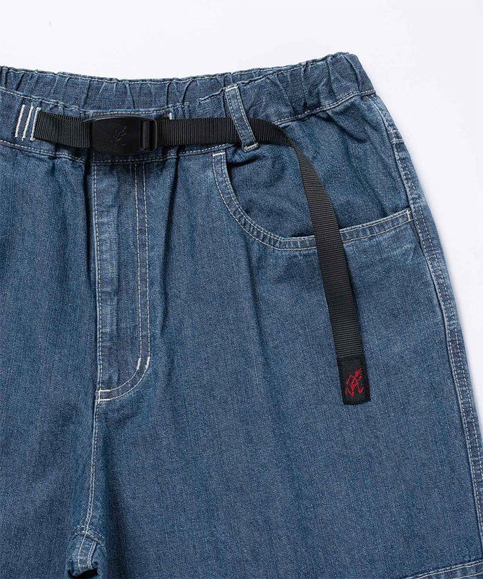Close-up of the blue Gramicci Japanese Chambray Double Knee pant with belt on a light tone background.