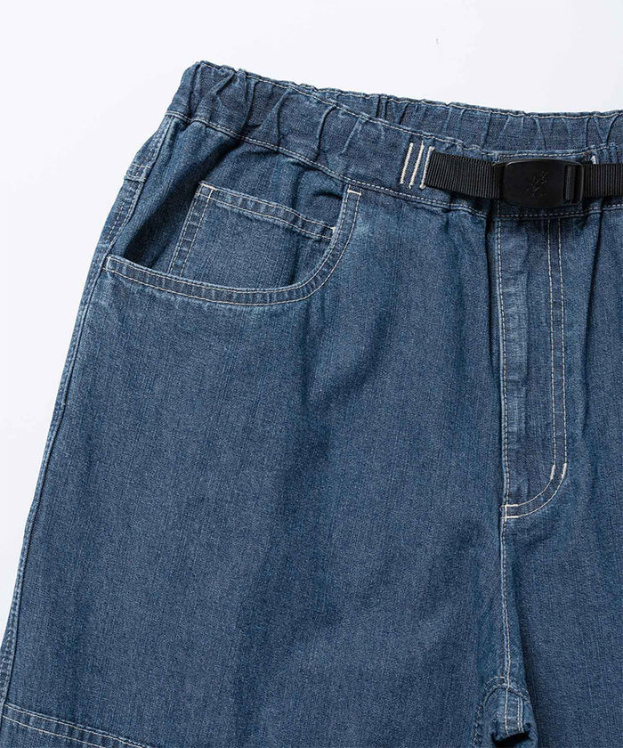 Close-up of the blue Gramicci Japanese Chambray Double Knee pant on a light tone background.